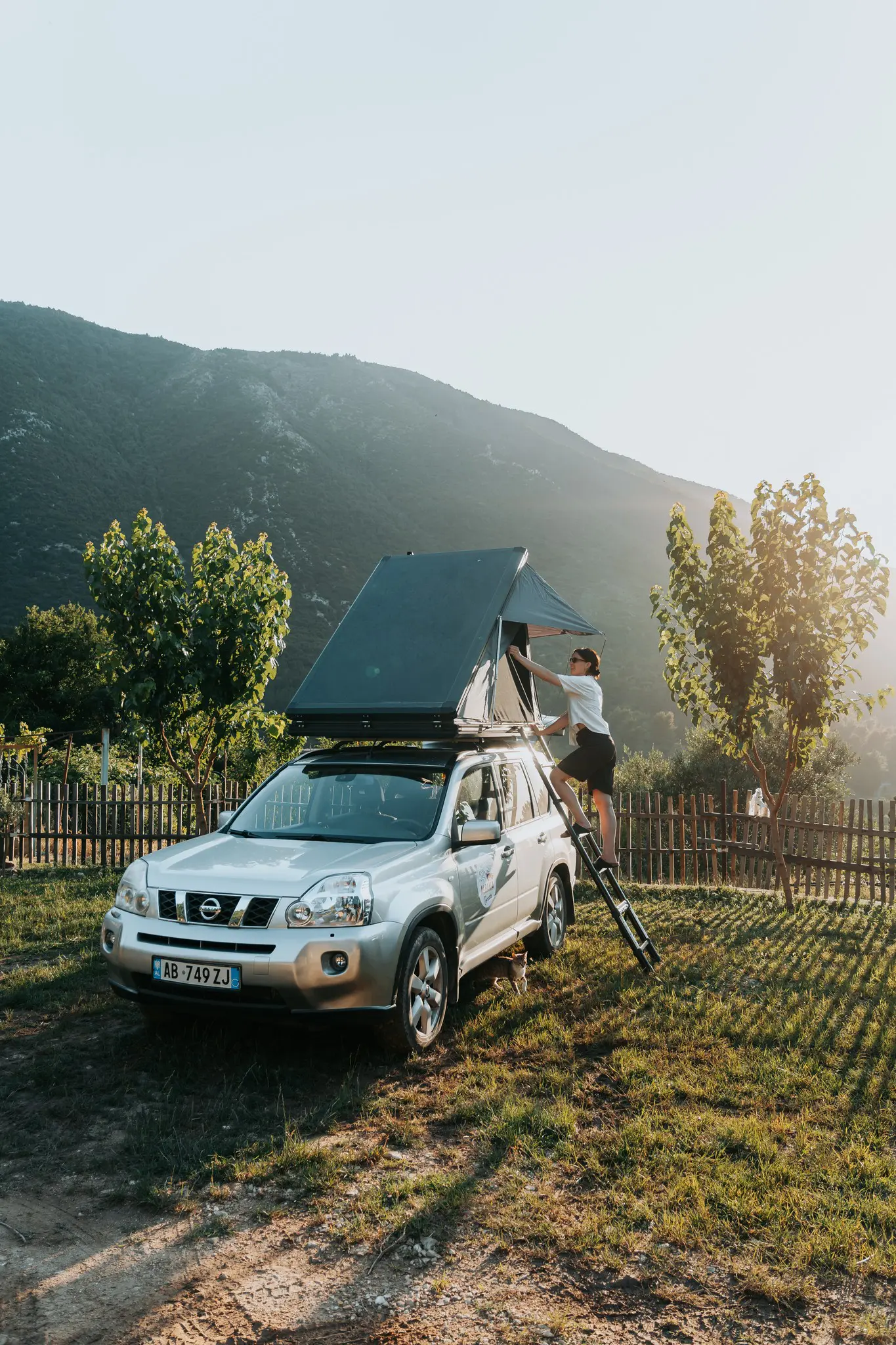 person setting up a rooftop tent on an SUV in Albania