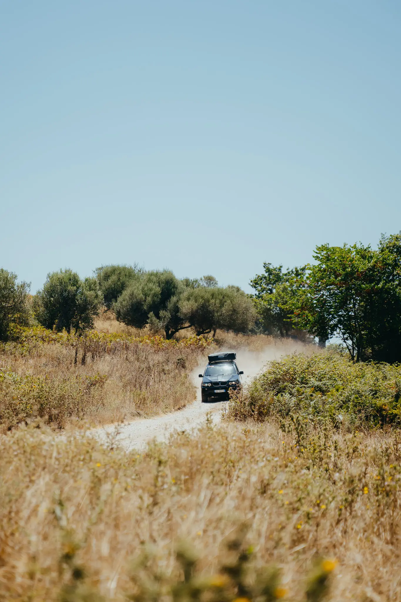 black car driving on a dusty road in Albania