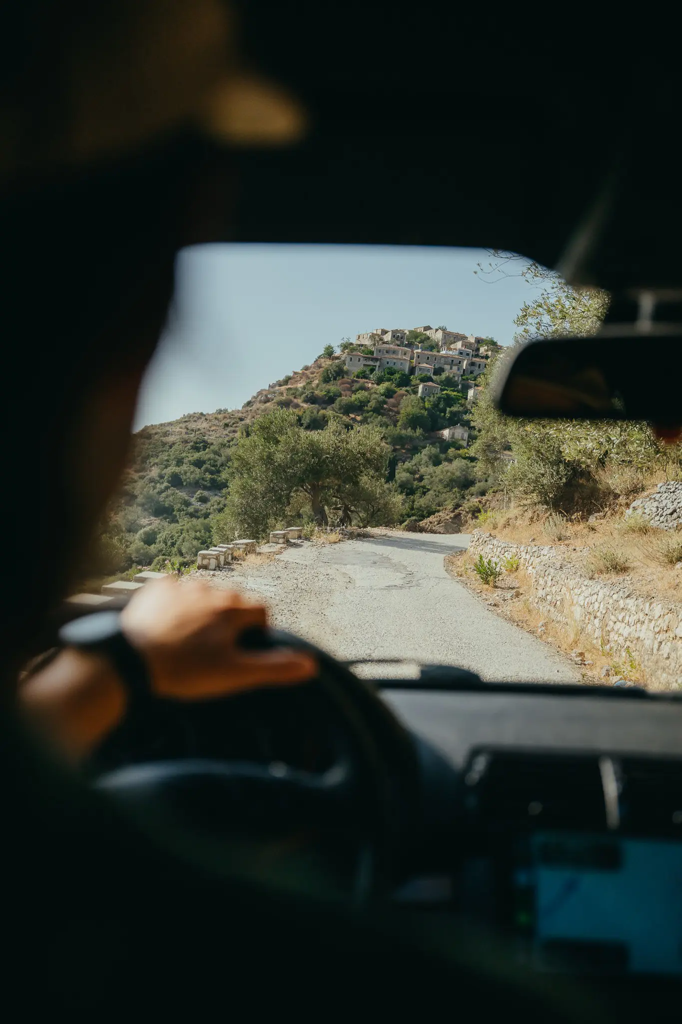 driving through Albanian mountains towards a village