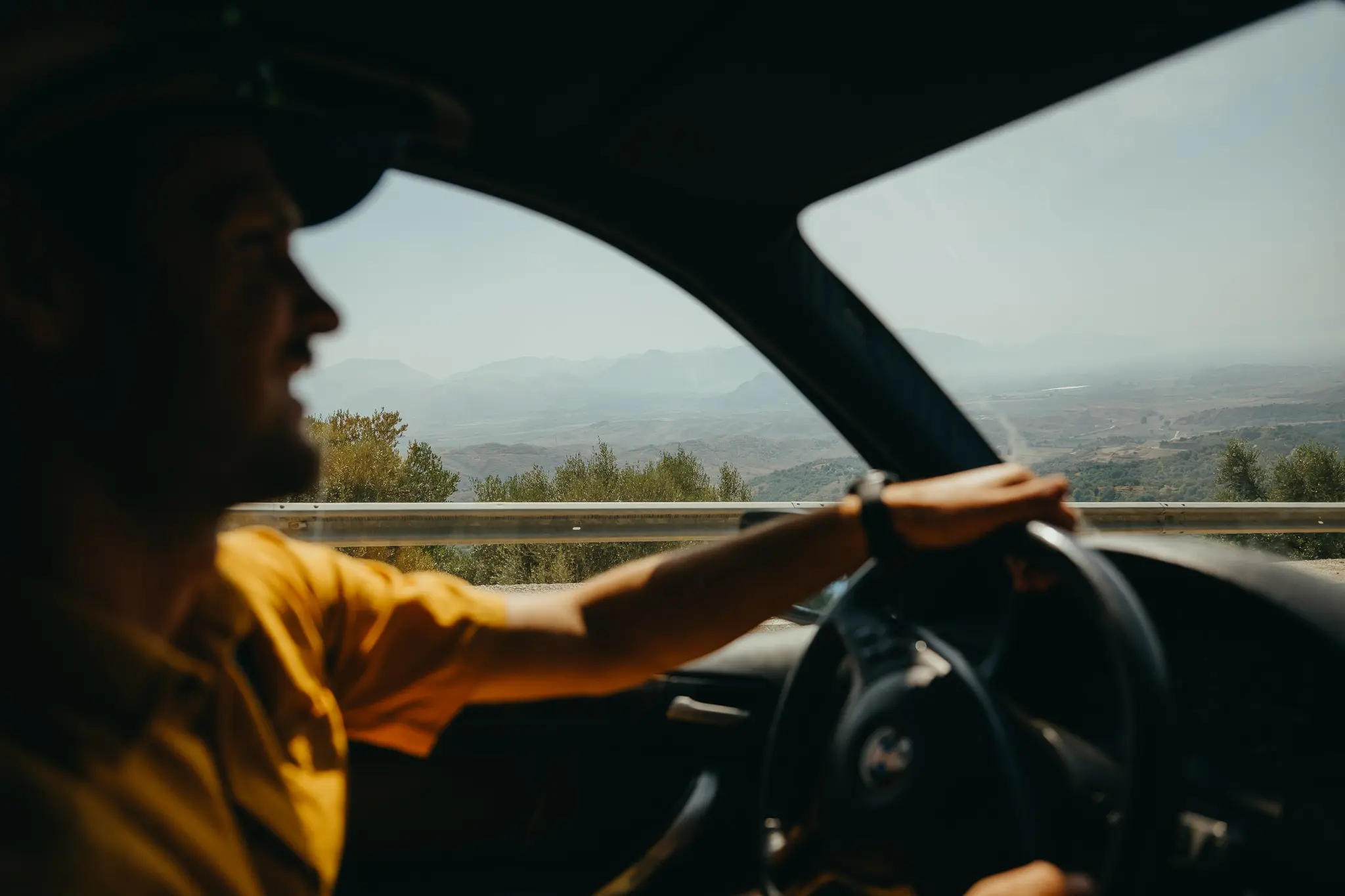 man driving car on mountain road in Albania