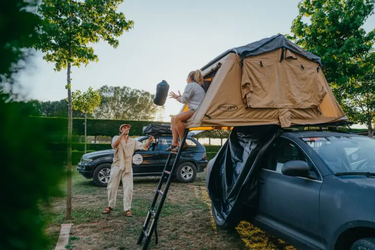 couple setting up rooftop tent on car in Albania